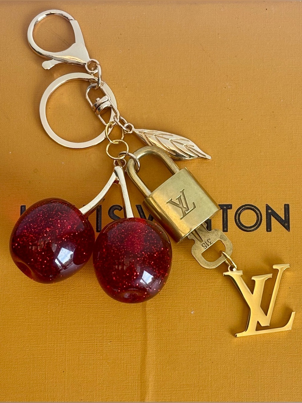 AUTHENTIC LOUIS VUITTON
BRASS LOCK & KEY #315, LARGE RED CHERRY BAG CHARM, 6 in
